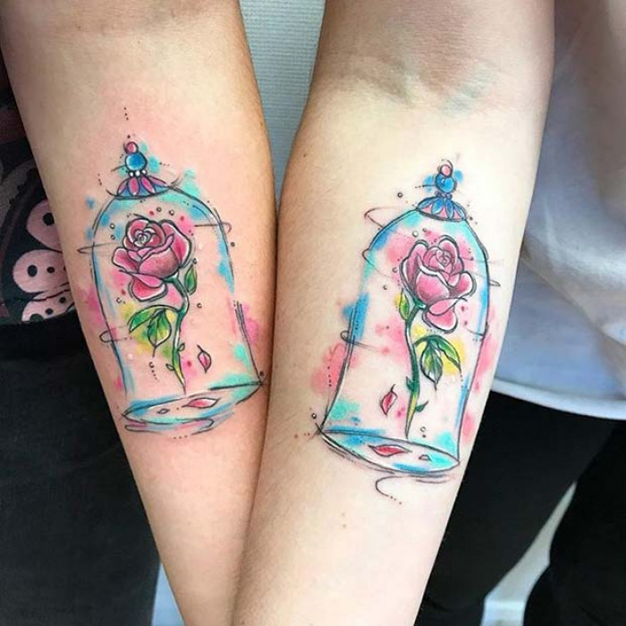 Matching enchanted rose tattoos