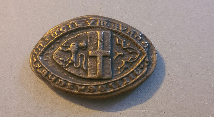 22. Small and heavy coin type of thing that was found in Germany.