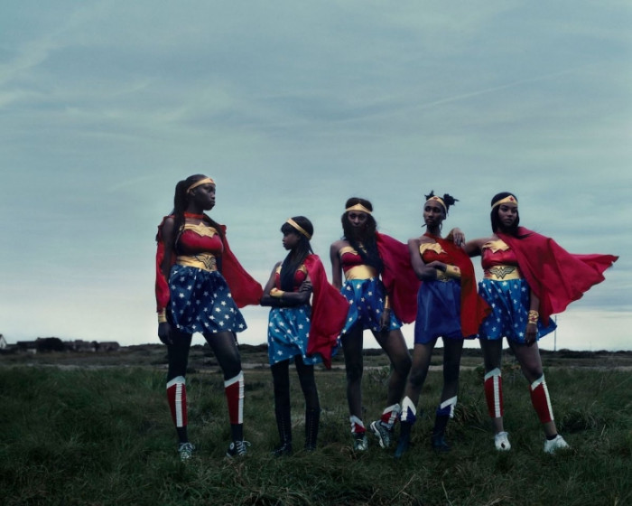 A group of Wonder Women in an empty field