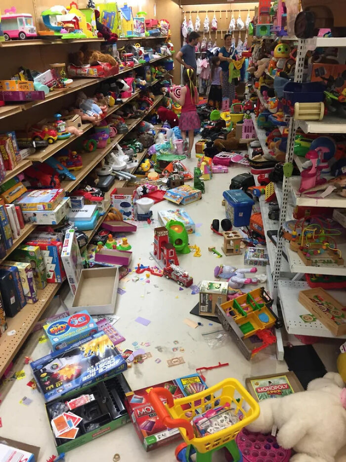 33. Children vandalize the thrift store's toy area while their parents remain indifferent.