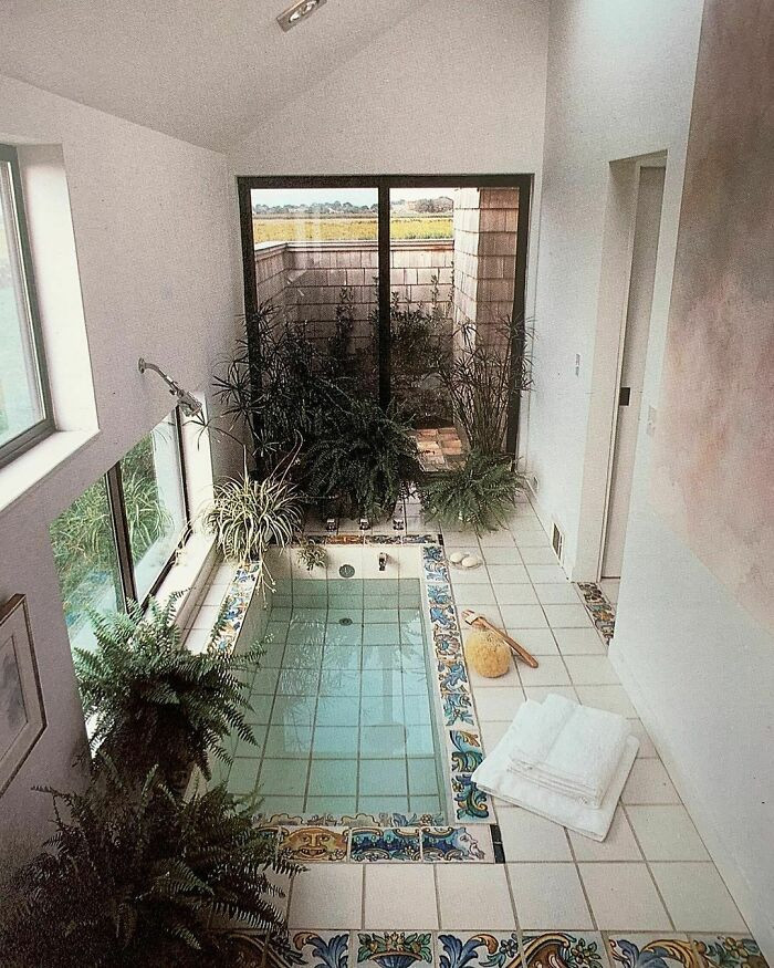 16. This Bathing Annex On The End Of A Modern Suburban Home Epitomizes Peace And Relaxation. A Sunken Tub Of Pure White Tile Is Trimmed With Hand-Painted Blue And Gold Tiles In A Room Equally Clean, Pure And Neatly Boarded By Tile, Plants, And Windows
