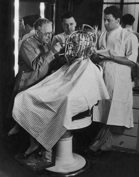 8. Max Factor takes precise measurements of a young woman’s head and face with his “Beauty Calibrator” (1932)