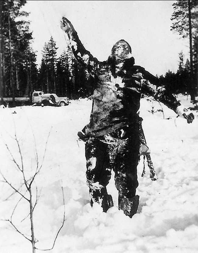 17. frozen Soviet fighter propped up by Finnish soldiers to serve as psychological warfare against the invading Soviets.