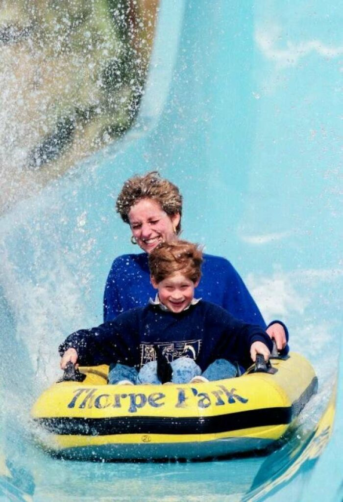 37. Princess Diana with Prince Harry riding a water slide in 1992