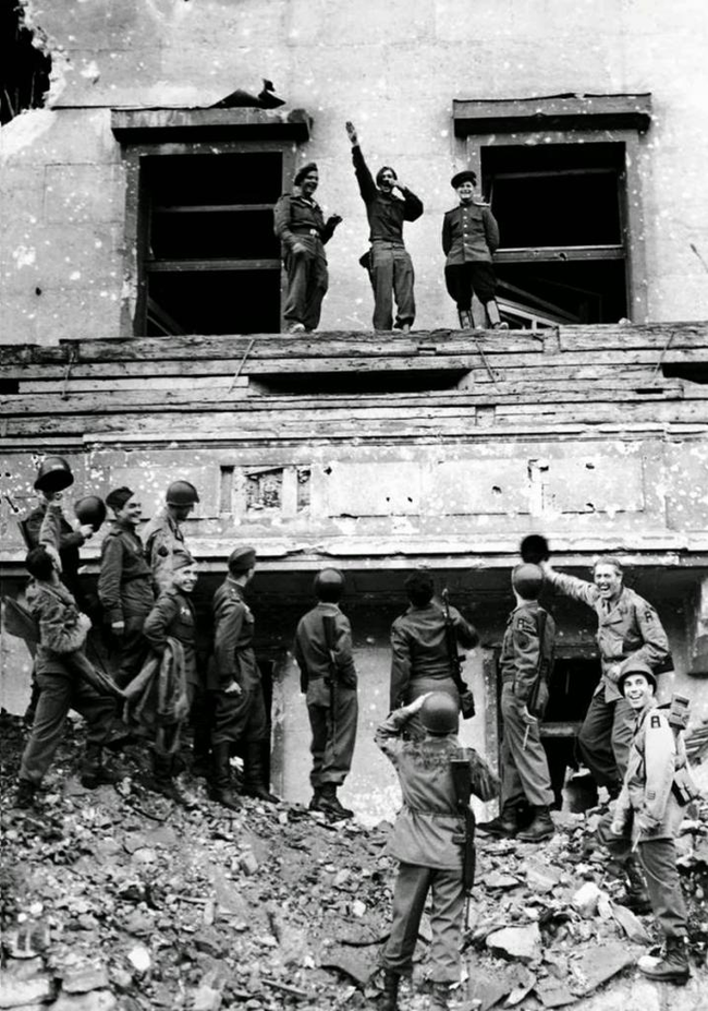 12. soldiers mock Hitler from the balcony of the Reich Chancellery in 1945.