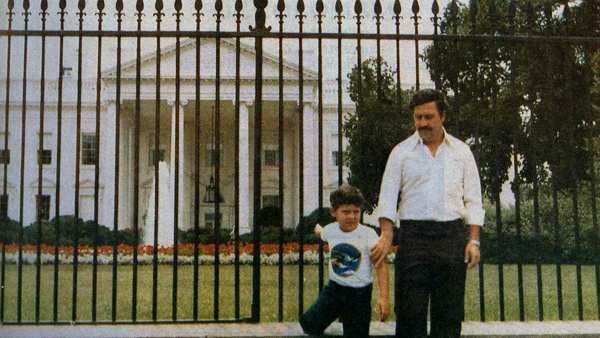 17.  In the early 1980s, drug lord Pablo Escobar and his son are seen standing in front of The White House.