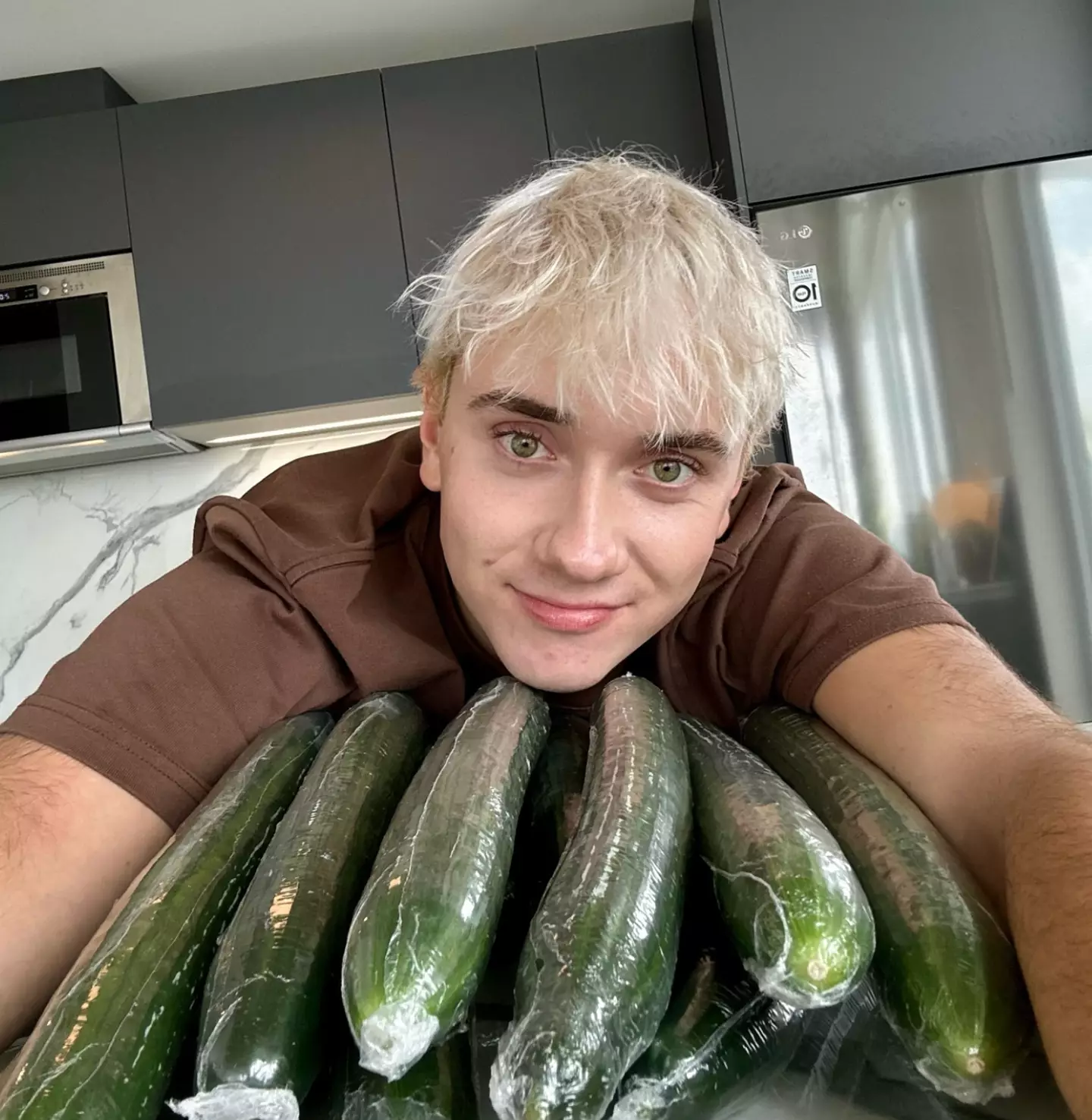 Logan Moffitt, the TikTok sensation behind the cucumber craze, showing off his prized haul.