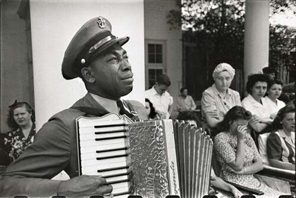 27. An accordion player mourning FDR at his funeral.